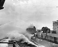 Photo # NH 99768:  USS Rich digging into a wave while steadying up alongside USS Wasp (CVS-18) for underway replenishment on 28 February 1961.