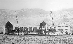 Historical photo of French torpedo cruiser Faucon modernized with two masts in front of the Vauban shipbuilding ways in the original part of the Toulon Arsenal