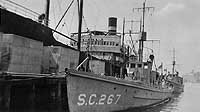 Photo #  NH 41990:  Freighter Clio in the background of a photo of USS SC-267 at Wakefield, Massachusetts, circa 1918-1919